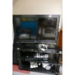 Modern 3 tier TV stand with a 32'' LG TV, Panasonic DVD player, Phillips radio and a video