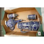 A collection of German Blue and White embossed steins, decanters, water jugs and tankards.