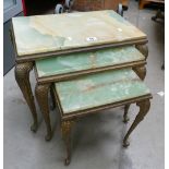 A green onyx and brass set of three tables.