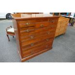 A large Satin wood chest of drawers with two smaller drawers beside central drawer above three