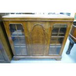 1920's Burr walnut cross banded glazed 3 door display cabinet on bracket feet.