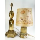 Large brass column type table lamp and similar smaller item with hand decorated parchment shade. (