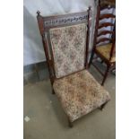 An aesthetic style oak parlour chair on turned legs with casters with upholstered floral seating and