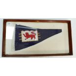 Framed commemorative pennant flag with lion motif on blue background, signed and dated 1964.