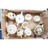 A collection of Sudlows cream and gold decorated tea pots, water jugs, sugar bowls, together with