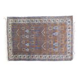 20th century hand knotted Afghan woolen rug decorated with deep blues, purples, golds and reds,