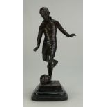 Bronze figure of footballer Stanley Matthews about to kick a ball on marble plinth,