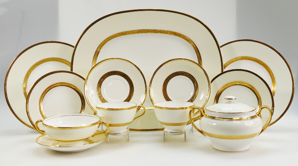 A large collection of Minton Gilt decorated dinnerware in the K100 pattern to include dinner plates,