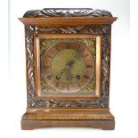 Edwardian burr and carved walnut mantle clock with brass dial,