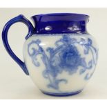 Macintyre pottery blue and white jug, c1900. Impressed mark to base. 13.5cm high.
