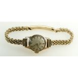 Omega ladies 9ct gold watch and 9ct bracelet. Winds, ticks and runs down keeping reasonable time.