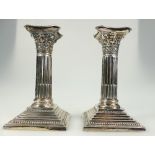 Pair of Corinthian column silver candlesticks (loaded) B'ham 1927.