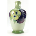 William Moorcroft Burslem vase decorated in the Pansy design on Celadon ground, height 20.