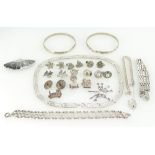 A collection of silver jewellery items including earrings, bangles, charm bracelet etc,