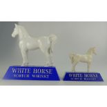 White Horse plastic advertising figure on blue base, height 23cm together with similar smaller item.