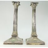 A pair of silver plated candlesticks with Corinthian columns,