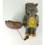 Early 20th century painted metal cigarette holder and ashtray as a comical cat in smoking jacket,