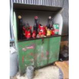 Large metal 1940's garage oil cabinet with various Esso and other serving oil cans,