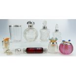 A collection of 19th century and later silver topped scent bottles and match strikers in cut glass,