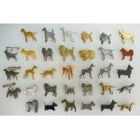 A collection of various metal vintage Kenart dog brooches (33)