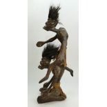 Indonesian primative tribal wood carving of two men,