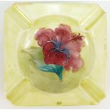 Moorcroft square ashtray decorated in the Hibiscus design on yellow ground,