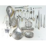 A collection of silver items including cutlery, brush sets etc,