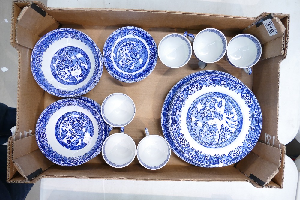 A collection of Meakin Old Willow patterned dinnerware to include saucers, dinner plates,