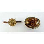 Yellow metal brooch set with amber and b