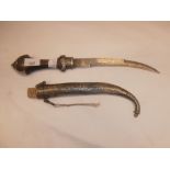 Arabic sheathed dagger with decorative white metal mounts scabbard