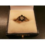 9ct gold dress ring set with central small diamond surrounded by sapphire