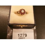 Gold dress ring set with an opal and garnets marks worn