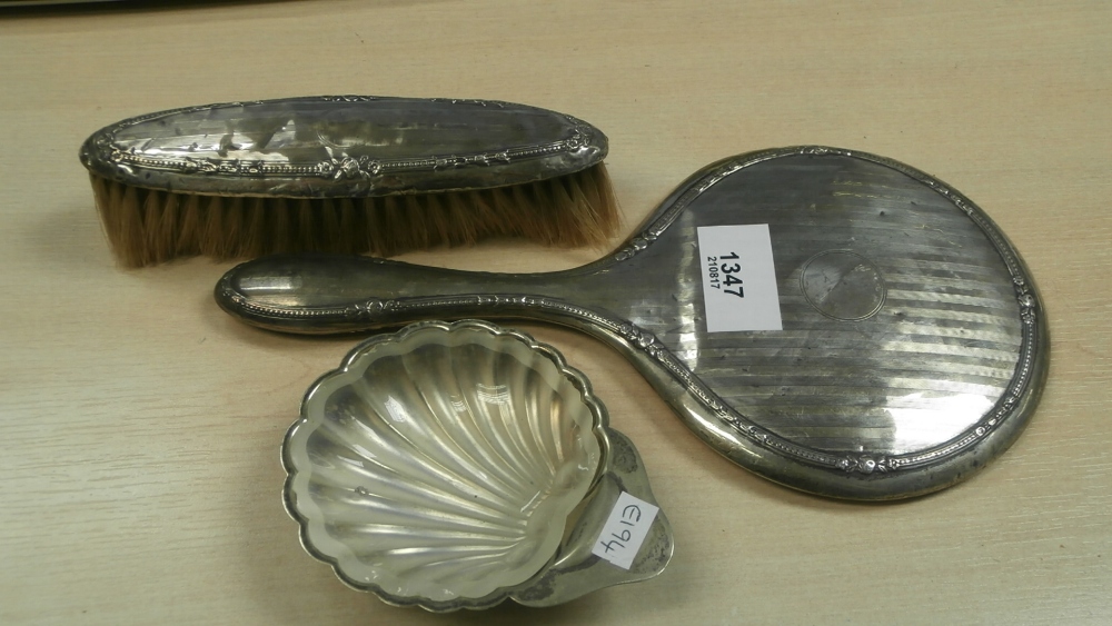 Silver backed hand mirror and matching clothes brush and silver plated shell shaped dish with