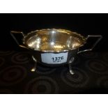 G ood quality heavy silver bowl with hammered decoration, pie crust edge, double handles on 4 pad