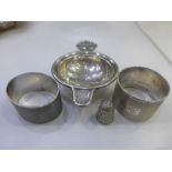 small collection of silver including 2 serviette rings, tea strainer and a thimble