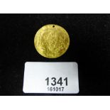 Antique gold coloured metal coin stamped with religious scenes