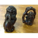 A carved hardwood netsuke depicting monkey within bamboo ring with inlaid bead eyes - mother-of-