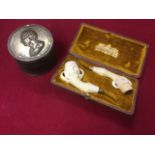 A cased pair of Victorian meerschaum claw carved pipes; and a tubular pot with brass mounts