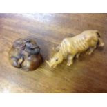 A carved hardwood netsuke depicting a baby elephant with ball, having inlaid bead eyes - signed