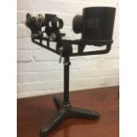 A Flatters & Garnett Ltd micro projection instrument with lenses and mirror on adjustable stand with