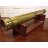 A 1907 brass day & night sight by W Ottawa & Co, Ealing, the numbered telescopic instrument on oak