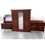 An Edwardian mahogany bedroom suite with wardrobe, dressing table & dressing cabinet, all pieces