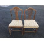 A period oak dining chair, with pierced splat to shield back, above an upholstered drop-in seat,