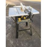 A Titan electric table saw, with adjustable guides, guard, etc, raised on angled legs.