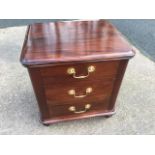 A small mahogany chest with moulded top above three drawers mounted with brass swan-neck handles,