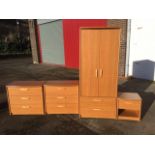 An Alstons teak style bowfronted four-piece bedroom suite, the wardrobe with two drawers below