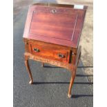 A small mahogany bureau, with panelled fallfront enclosing pigeonholes & drawer above an oval