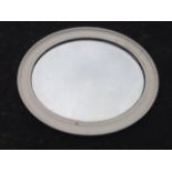 A painted oval Edwardian mirror, with moulded frame around a bevelled plate.