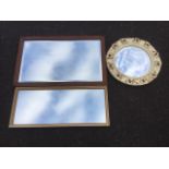 A circular convex mirror in cream leaf moulded frame; a rectangular mirror in gilt frame; and an oak