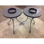 A pair of circular metal garden tables, the pierced tops with ribbed rims supported on scrolled